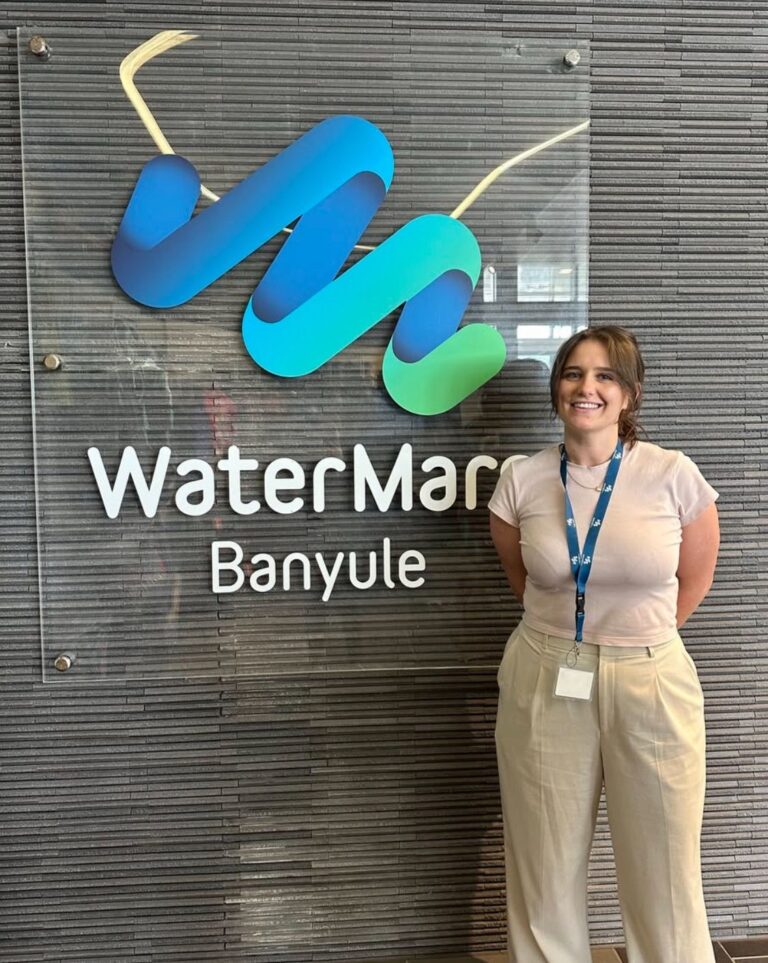 Renee standing in front of WaterMarc sign